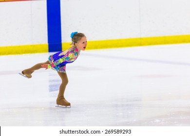 Young Figure Skater Practicing At Indoor Skating Rink.