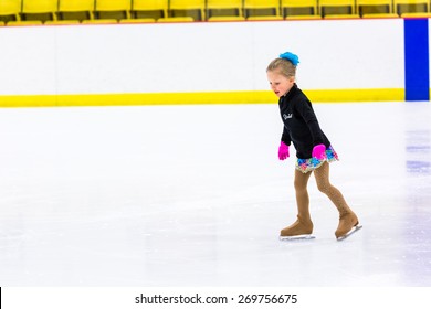 Young Figure Skater Practicing At Indoor Skating Rink.