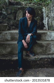 A Young Filipino Man In Deep Thought, Contemplating The Future Or Problematic. Blank Stare And Emotionless, Sitting On Some Dirty Concrete Steps.