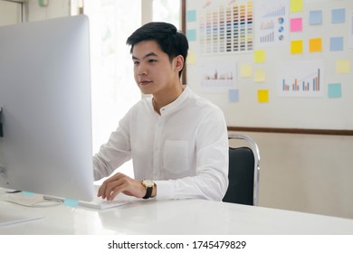 Young Finance Market Analyst Working At Office And Analyze Online Marketing In His Computer.