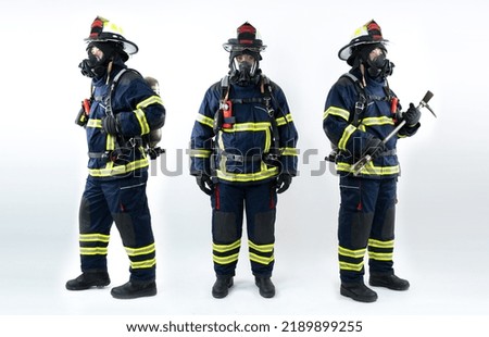 Young fireman with a mask | Full body young brave man in uniform and hard hat of fireman holds axe and looking