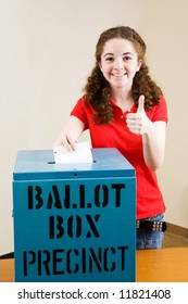 Young First Time Voter Casting Her Ballot And Giving A Thumbs-up Sign.