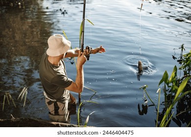 Young fisherman with fishing rod near the lake at summer - Powered by Shutterstock