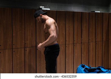 Young Fit Adult Man Changing Clothings In Locker Room Of Gym Facility