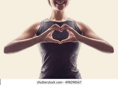 Young Fit Asian Woman Make Heart Shape By Her Hands.