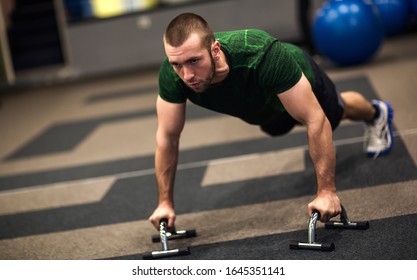 Young fit athletic man doing push-ups - Shutterstock ID 1645351141