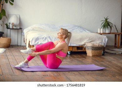 young fit girl doing plank mat in sport outfit doing online workout at home, recording online aerobic tutorials from home, exercise 