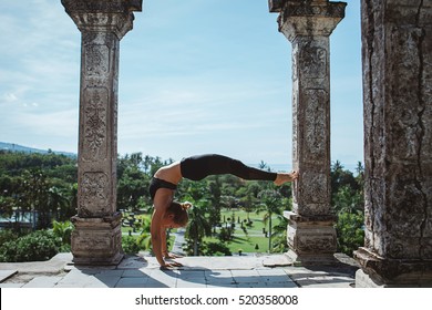 Young Fit Girl Practicing Yoga And Meditation During Her Yoga Retreat Vacation In Bali