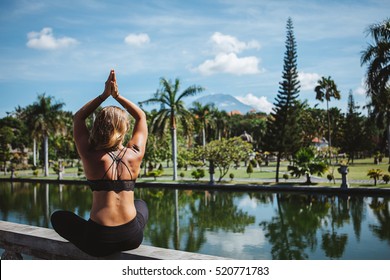 Young Fit Girl Practising Asana And Meditation During Her Yoga Retreat Luxury Vacation In Bali