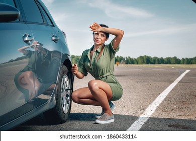 Young Fit Girl Is Tired To Fix A Wheel Of Her Broken Car By Socket Wrench Under The Hot Sun