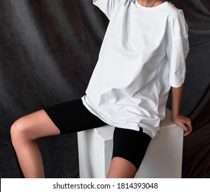 Young Fit Girl Wears Oversized White T Shirt With White Legging Shorts. Copy Space Street Wear Woman Outfit Mock Up