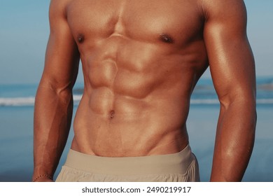 Young fit handsome asian man training on the beach, good physic, sporty, athlete, outdoor fitness, blue sky, muscle body, abdominal muscles, abs, six-pack
 - Powered by Shutterstock