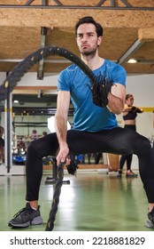 Young Fit Male Working Out In The Gym, Rope Strength Workout