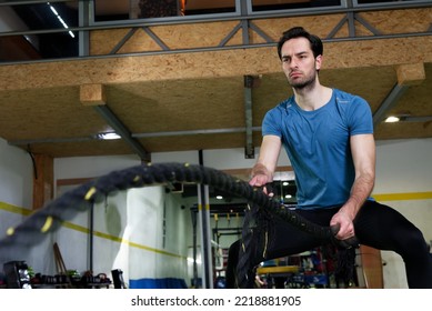 Young Fit Male Working Out In The Gym, Rope Strength Workout