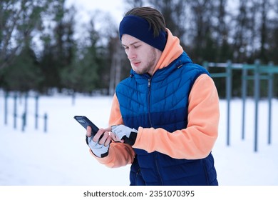 Young fit man is training workout outdoors at winter cold snowy day. Healthy fitness lifestyle concept.  - Powered by Shutterstock