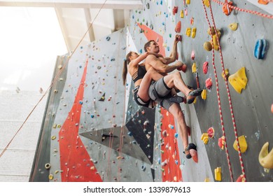 Young Fit Man And Woman Have Joined A Climbing Gym. Low View. Full Length Photo. Speed Freestyle