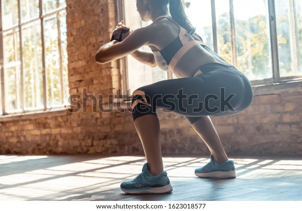 Young Fit Sporty Active Athlete Woman Wear Sportswear Crouching Doing Squats Session Fitness