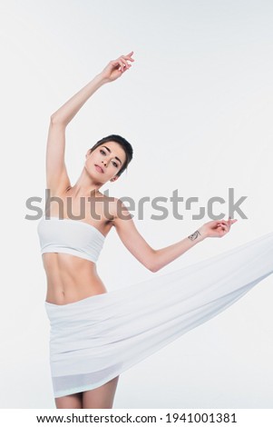 Young fit woman in bra and fabric isolated on white