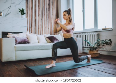 Young Fit Woman Do Frontal Lunges Or Squat Exercise Indoors In Living Room. Online Indoors Workout. Training At Home