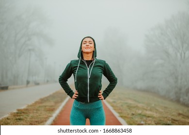 Young fit woman is getting ready for training outside. Fit girl is enjoying in fresh air. - Powered by Shutterstock