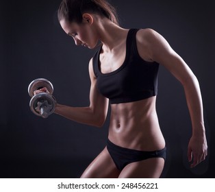  Young Fit Woman Lifting Dumbell On Black Background