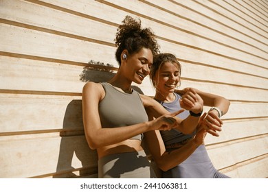 Young fit woman looking at smartwatch and counting calories burned. Healthy life concept  - Powered by Shutterstock