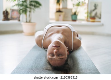 Young Fit Woman Practice Yoga Doing Asana In Light Yoga Studio With Green House Plants