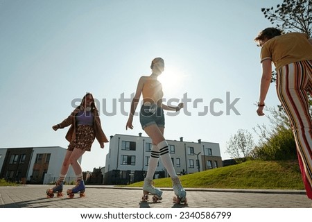 Similar – Young man riding on skate and holding surfboard