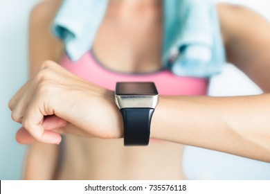 Young Fit Woman Using Smart Watch At The Gym. 