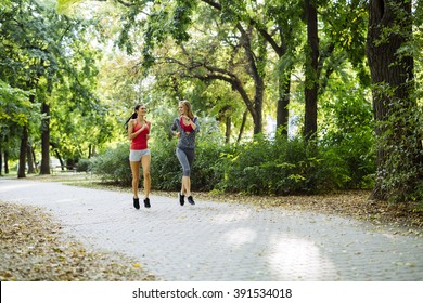 Young fit women jogging outdoors and staying fit - Shutterstock ID 391534018