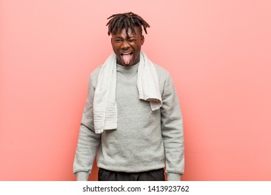 Young Fitness African Black Man Funny And Friendly Sticking Out Him Tongue.