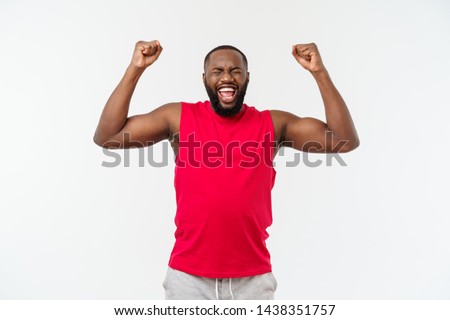 Similar – Cheerful man celebrating his success with a broad smile and raised fist in front of a neutral background