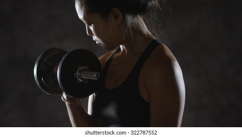 Young Fitness Asian Woman Lifting Weights With Arms Sweating