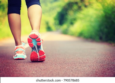 Young fitness female runner legs ready for run on forest trail  - Shutterstock ID 790578685