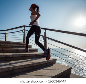 Young fitness female runner running up on seaside stairs - Shutterstock ID 1680346447