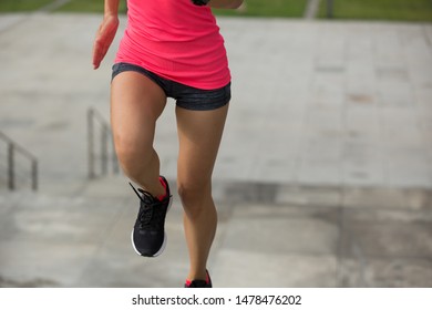 Young fitness sports woman running upstairs on stone stairs
