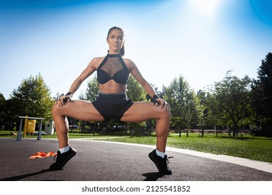 Young fitness woman doing plie squats with calf raise.