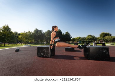 Young Fitness Woman Doing Tricep Dips In The Park.