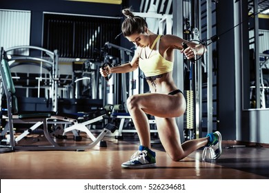 young fitness woman execute exercise with exercise-machine Cable Crossover in gym, horizontal photo. - Shutterstock ID 526234681