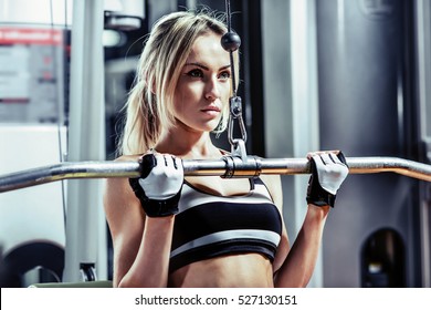 young fitness woman execute exercise with exercise-machine in gym, horizontal photo - Shutterstock ID 527130151