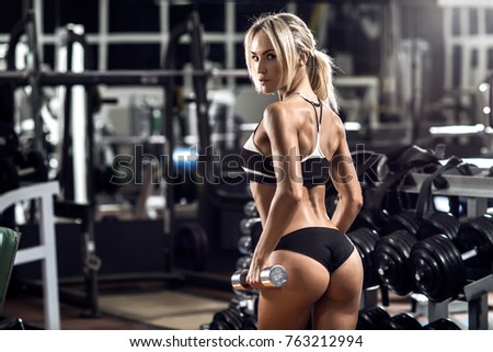 young fitness woman execute exercise in gym, horizontal photo
