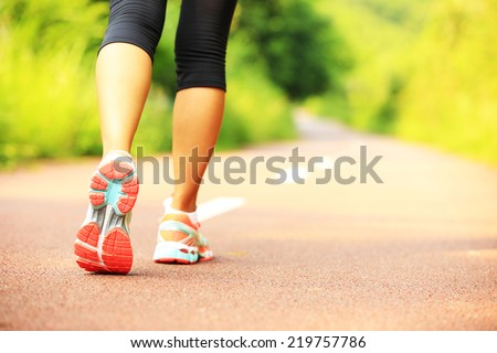 young fitness woman hiker legs  at forest trail 