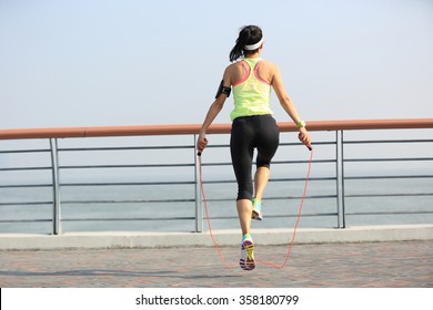 Young Fitness Woman Jumping Rope At Seaside