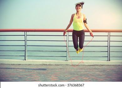 Young Fitness Woman Jumping Rope At Seaside