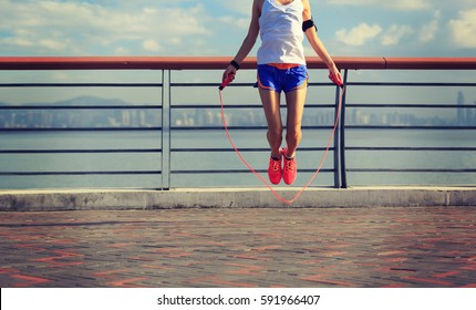 Young Fitness Woman Jumping Rope At Seaside