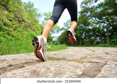 Young Fitness Woman Legs Running At Forest Stone Trail