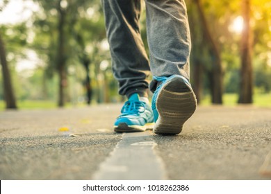 Young Fitness Woman Legs Walking In The Park Outdoor, Female Runner Running On The Road Outside, Asian Girl Jogging And Exercise On Footpath In Sunlight Morning. Healthcare And Well Being Concepts