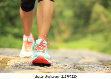 young fitness woman legs walking on forest trail  - Shutterstock ID 218997220