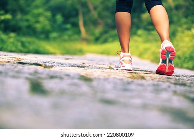 young fitness woman legs walking on forest trail  - Powered by Shutterstock