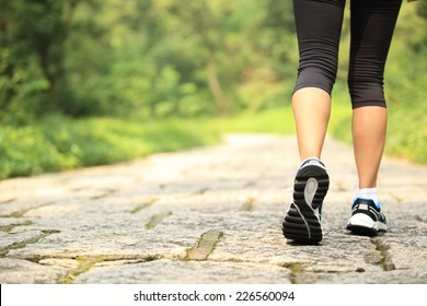 Young Fitness Woman Legs Walking At Forest Trail 